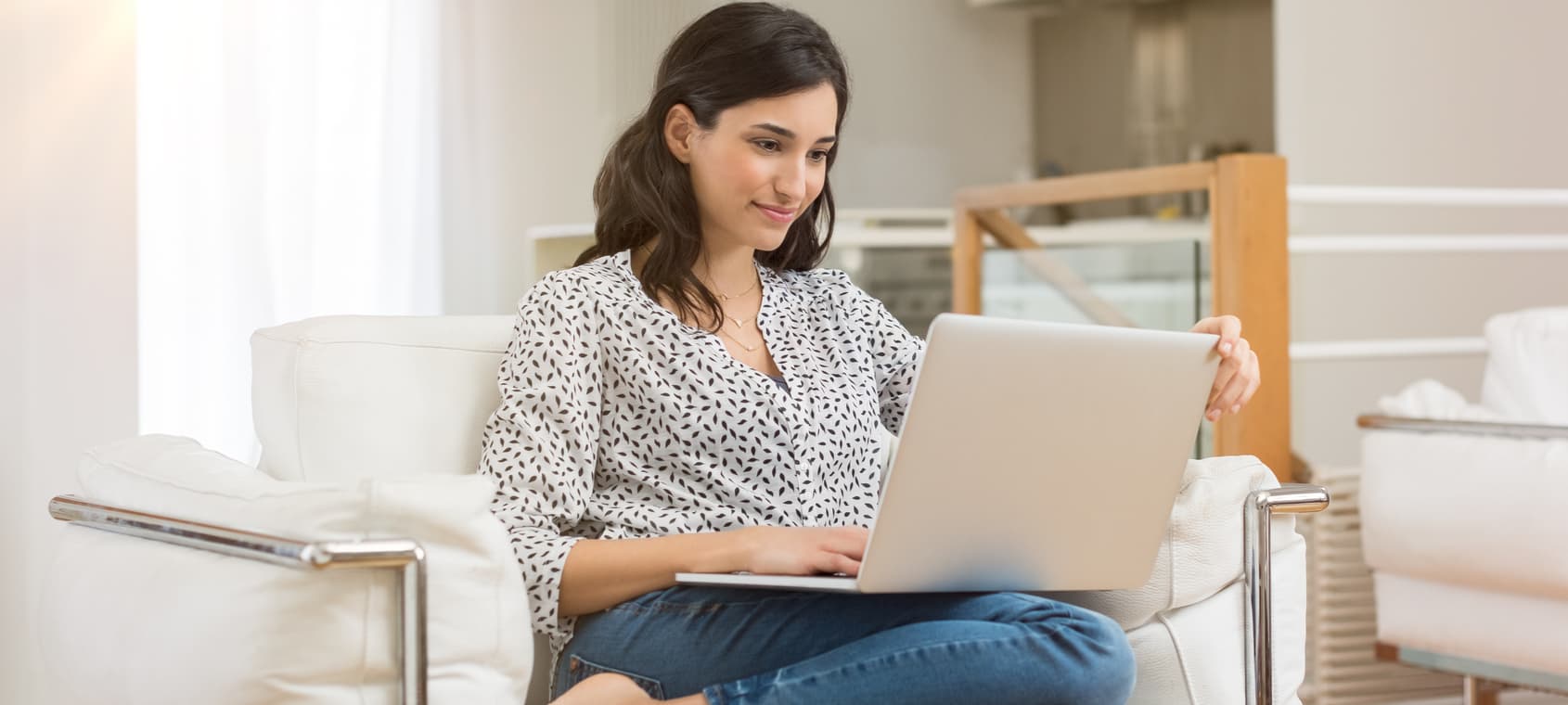 Woman researching while sitting on her couch