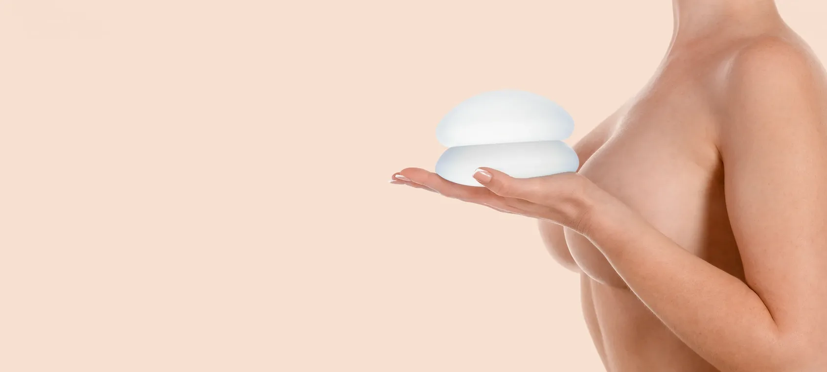 woman holding breast implants