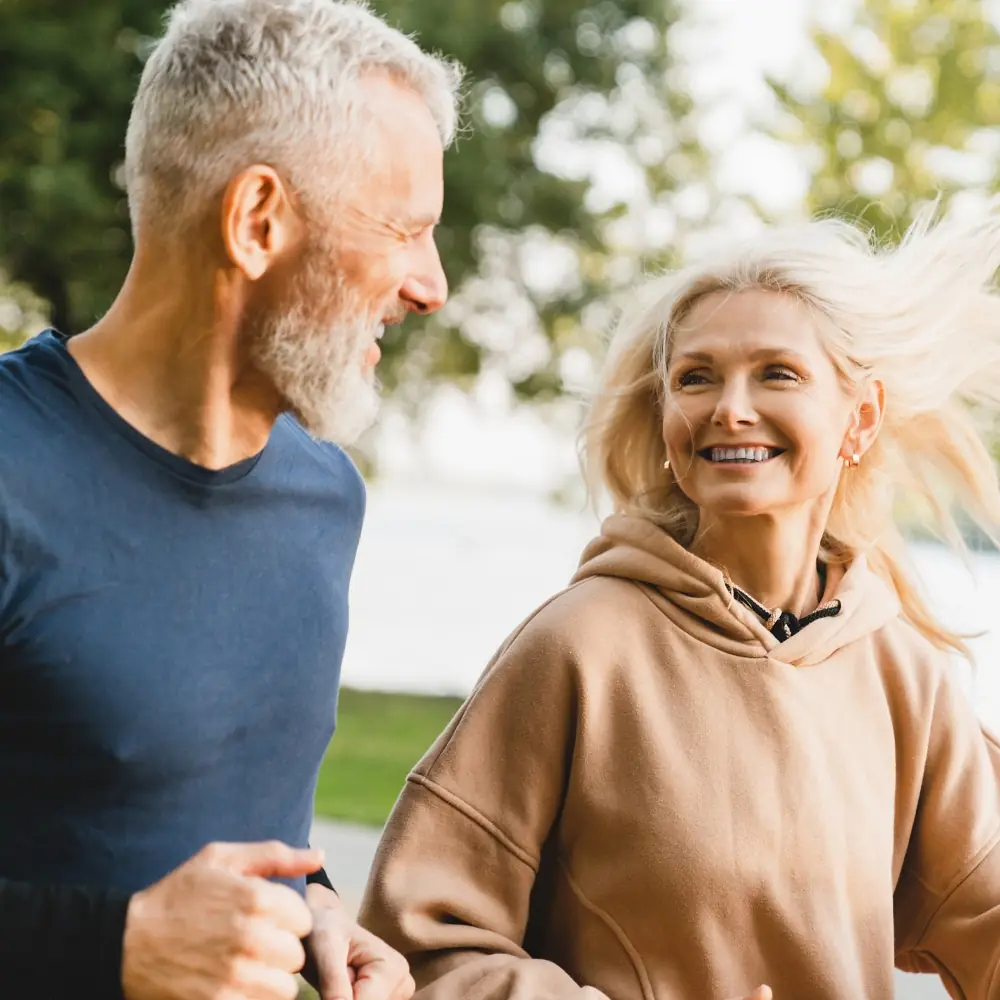 Middle age healthy couple outside at the park